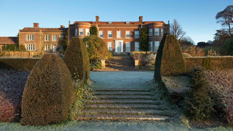 View in winter up garden steps to the house at Hinton Ampner, Hampshire
